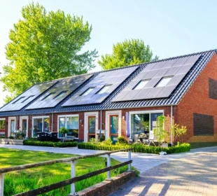 A residential home with solar panels installed on the roof, surrounded by green trees and a well-maintained garden, representing eco-friendly home improvements