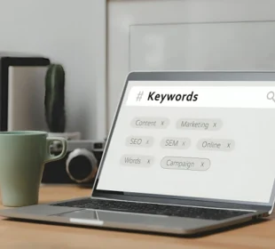 Laptop screen showing SEO keyword research and digital marketing tags illustrating the role of keywords in search engine optimization