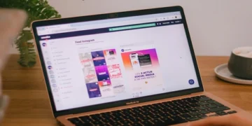 Laptop displaying Instagram feed dashboard on a desk, representing anonymous social media browsing and online privacy tools