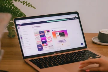 Laptop displaying Instagram feed dashboard on a desk, representing anonymous social media browsing and online privacy tools