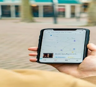 Person holding a smartphone showing a local search map for nearby businesses
