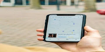 Person holding a smartphone showing a local search map for nearby businesses