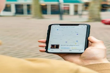 Person holding a smartphone showing a local search map for nearby businesses