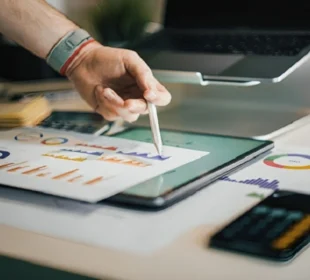 Digital marketing data analysis on tablet showing charts and graphs for small business growth strategy