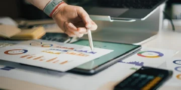 Digital marketing data analysis on tablet showing charts and graphs for small business growth strategy