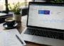 Laptop displaying Google Search Console dashboard beside a notebook listing free SEO tools for beginners